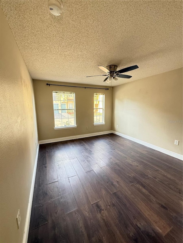 unfurnished room featuring ceiling fan, dark hardwood / wood-style flooring, and a textured ceiling