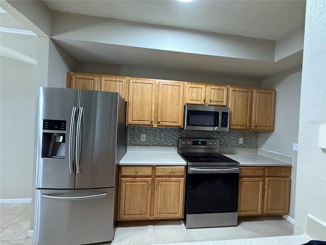 kitchen featuring stainless steel appliances and decorative backsplash