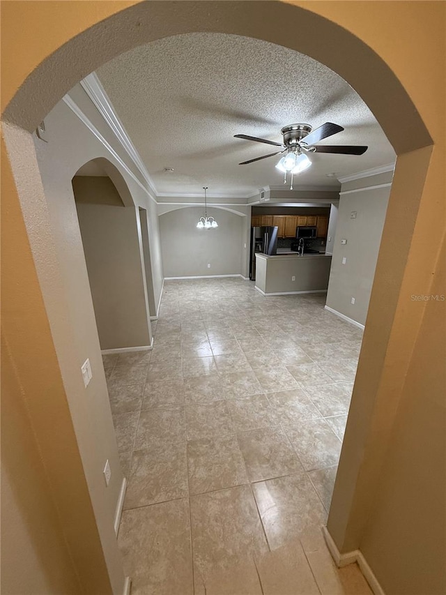 interior space featuring ceiling fan with notable chandelier and ornamental molding