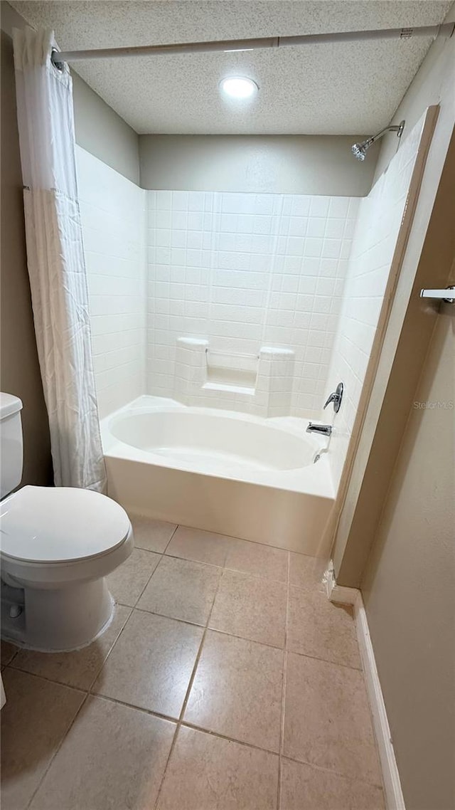 bathroom with a textured ceiling, shower / tub combo with curtain, tile patterned floors, and toilet