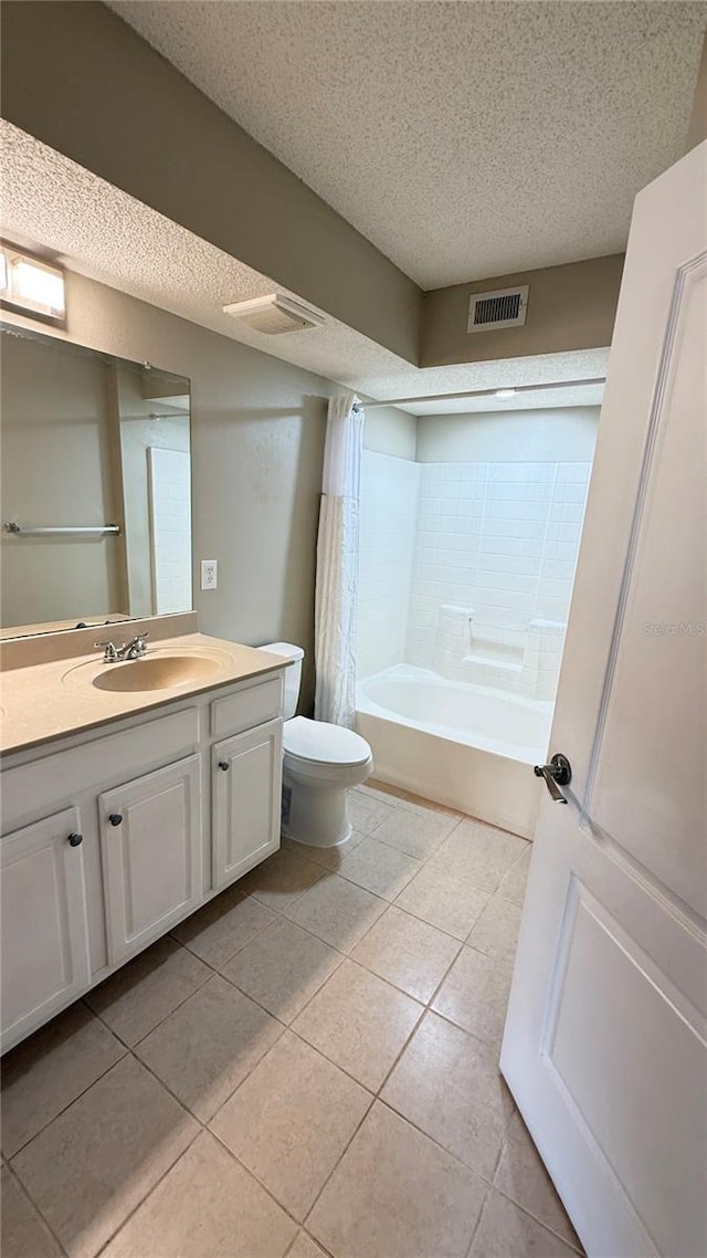 full bathroom with tile patterned flooring, toilet, vanity, shower / bath combo, and a textured ceiling