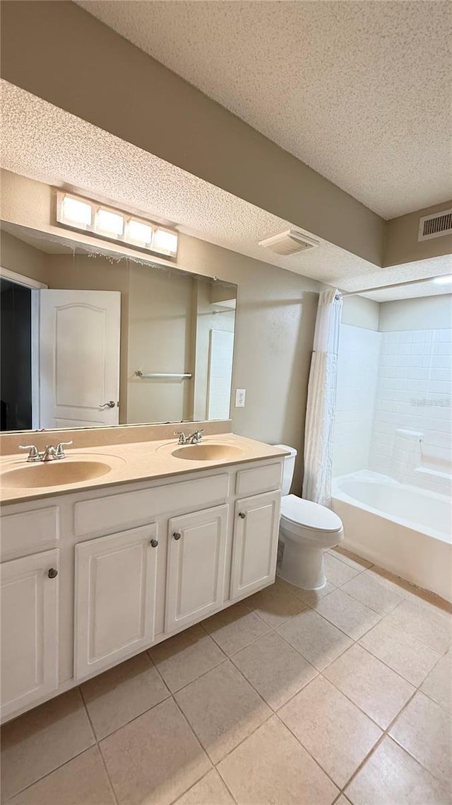 full bathroom with toilet, a textured ceiling, tile patterned flooring, shower / bath combination with curtain, and vanity