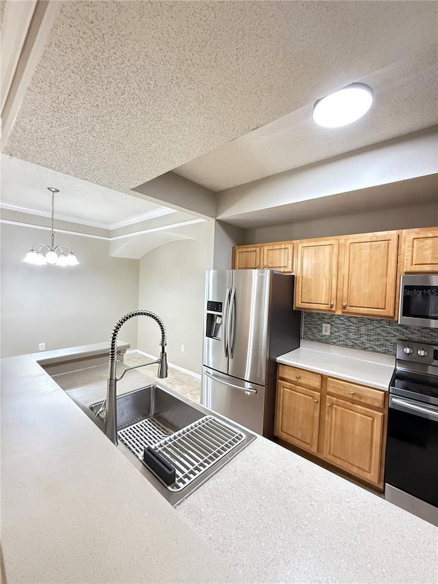 kitchen with a chandelier, hanging light fixtures, backsplash, appliances with stainless steel finishes, and sink