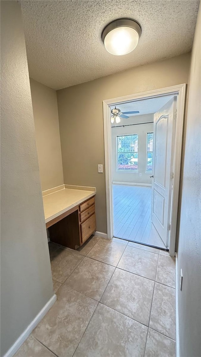 bathroom featuring tile patterned flooring, a textured ceiling, and ceiling fan