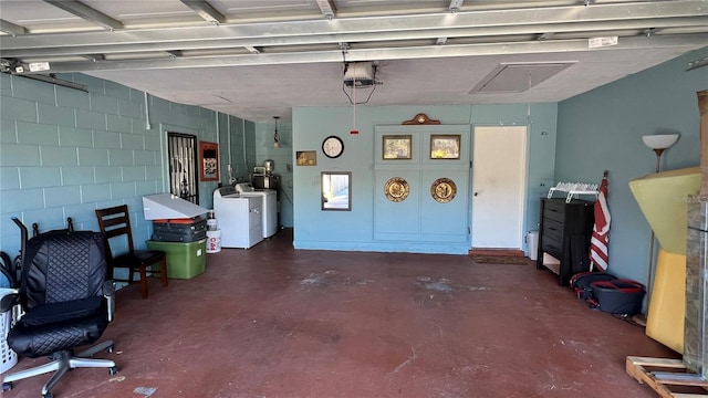 garage featuring separate washer and dryer and a garage door opener