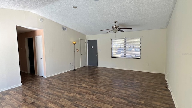 spare room featuring lofted ceiling, a textured ceiling, dark wood-type flooring, and ceiling fan