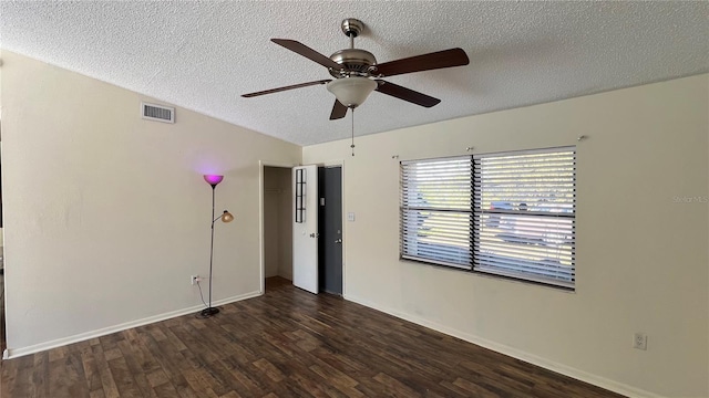 empty room featuring dark wood-type flooring, ceiling fan, lofted ceiling, and a textured ceiling