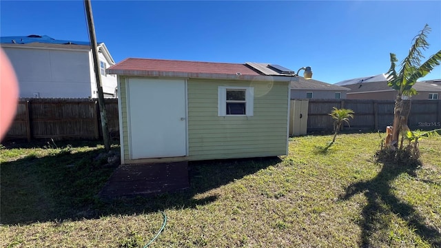 view of outbuilding with a lawn and solar panels