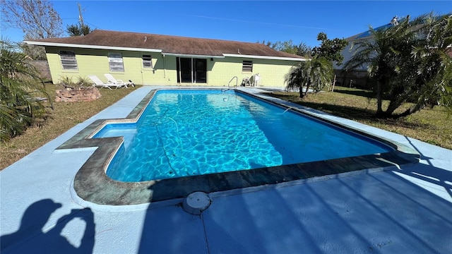 view of pool with a yard