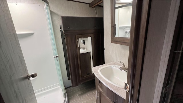 bathroom with vanity and a shower with shower door