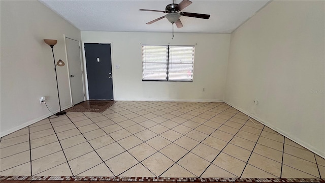 unfurnished room featuring ceiling fan and light tile patterned floors