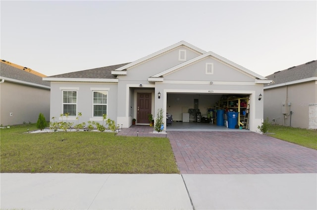 single story home with a front yard and a garage