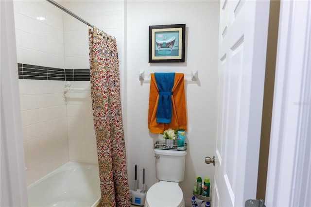 bathroom featuring shower / bath combo and toilet