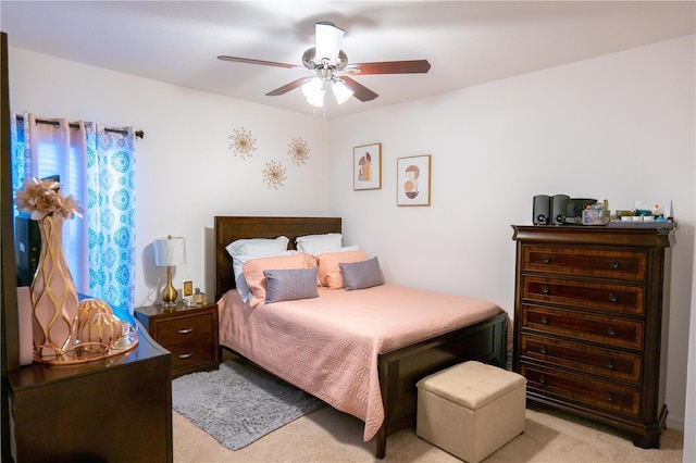 bedroom with ceiling fan and light carpet