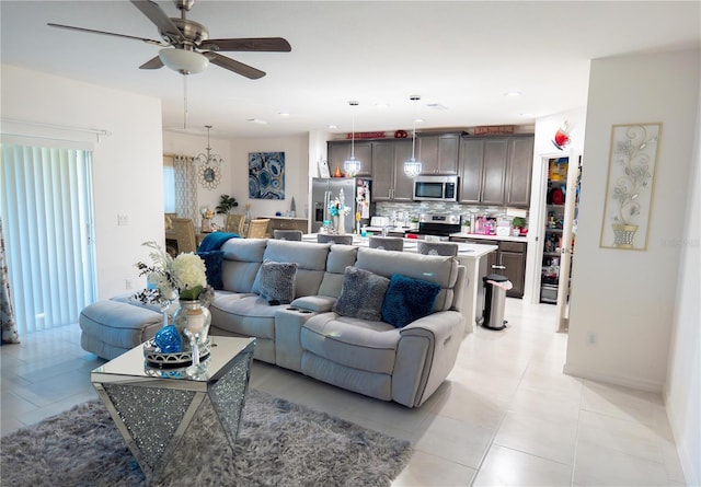 tiled living room with ceiling fan