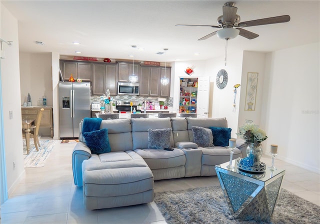 living room with light tile patterned floors and ceiling fan