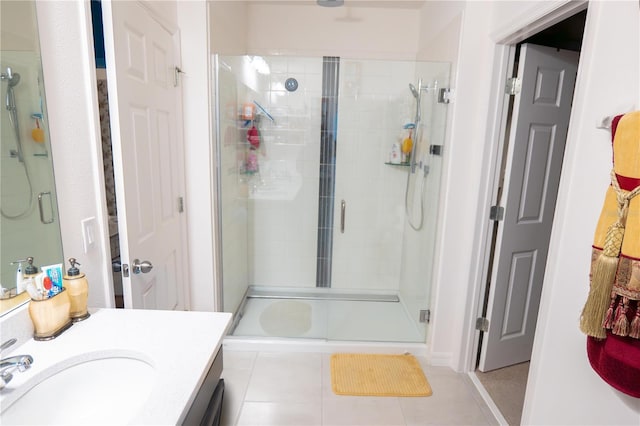 bathroom with tile patterned floors, vanity, and walk in shower