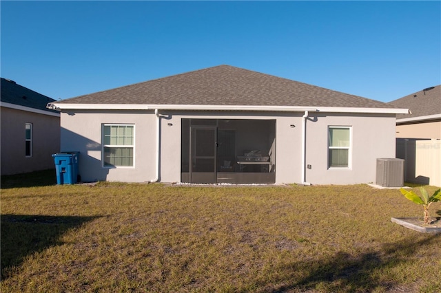 back of house with a lawn, a sunroom, and cooling unit