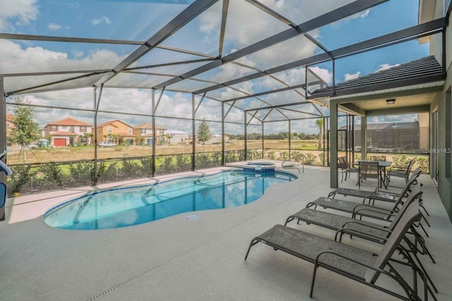 view of swimming pool with glass enclosure, an in ground hot tub, and a patio