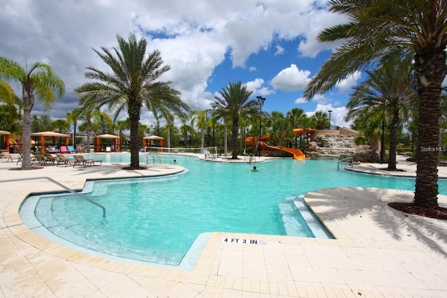 view of pool featuring a patio area and a water slide