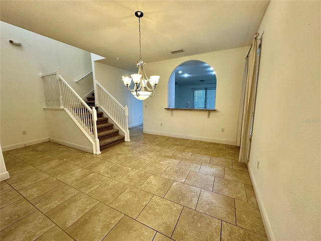 unfurnished dining area featuring a notable chandelier