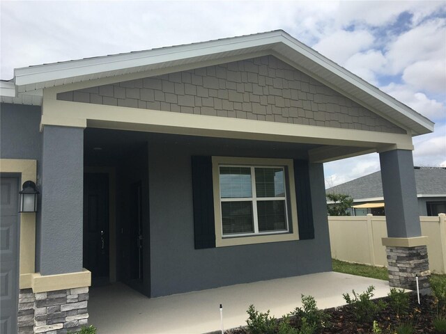 view of property exterior with covered porch