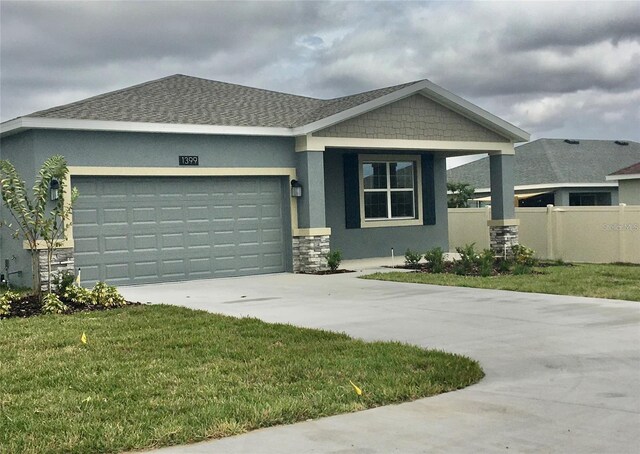 view of front of home featuring a front yard and a garage