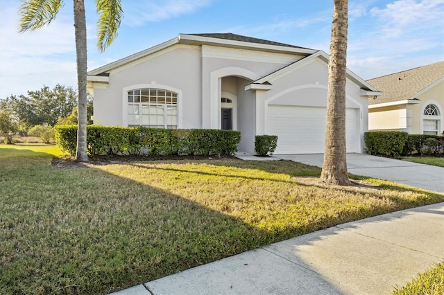 single story home featuring a garage and a front lawn