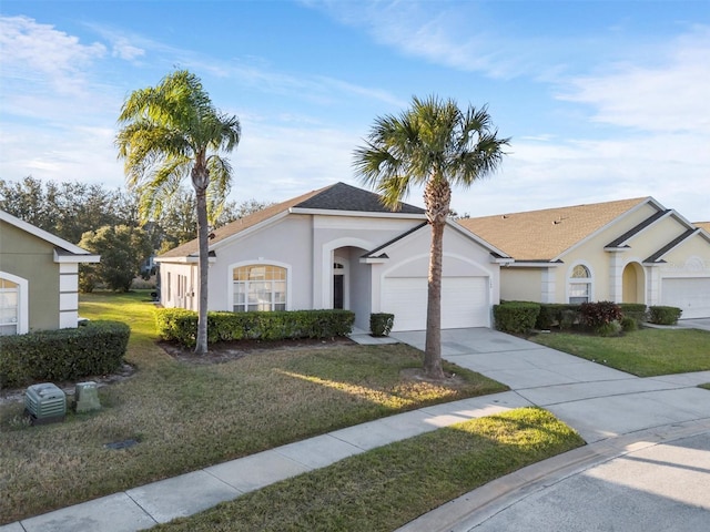 ranch-style home featuring a front lawn and a garage