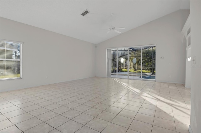 spare room featuring light tile patterned floors, a wealth of natural light, and ceiling fan