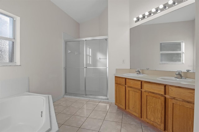 bathroom with tile patterned flooring, vanity, and separate shower and tub