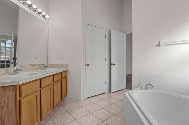 bathroom featuring vanity, tiled bath, and tile patterned floors