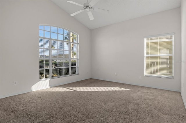 spare room with light colored carpet, vaulted ceiling, and ceiling fan