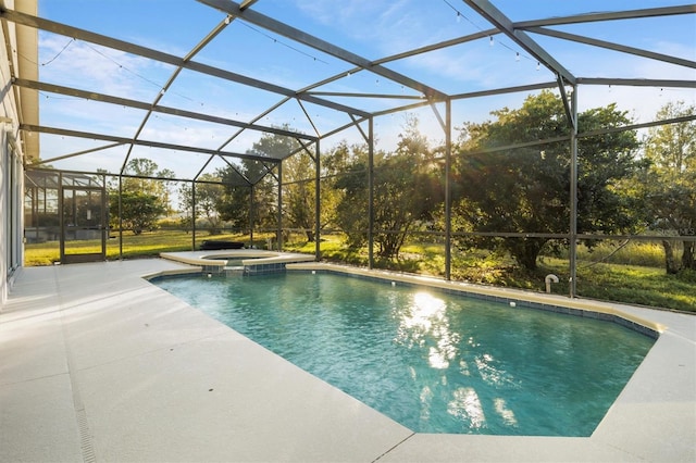 view of swimming pool with an in ground hot tub, glass enclosure, and a patio area