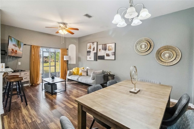 dining room featuring dark wood-type flooring and ceiling fan with notable chandelier