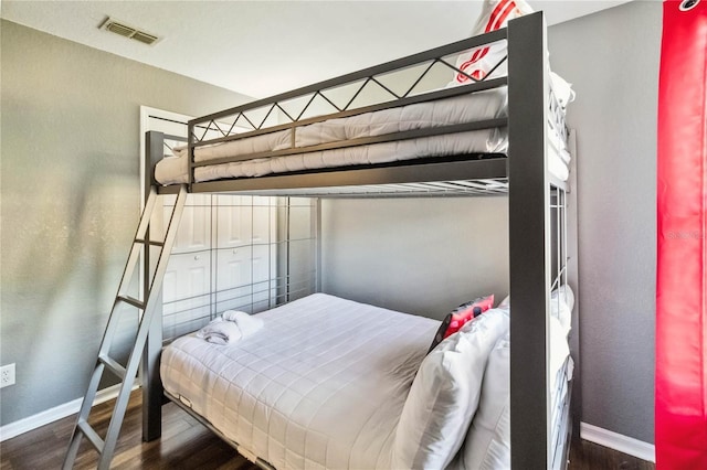 bedroom with dark hardwood / wood-style flooring