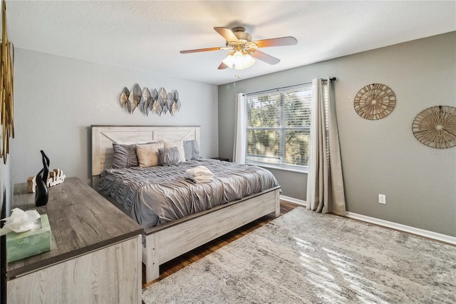 bedroom with ceiling fan and dark hardwood / wood-style floors