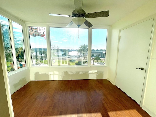 unfurnished sunroom with ceiling fan and a healthy amount of sunlight