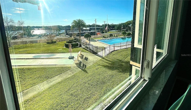 view of swimming pool featuring a lawn