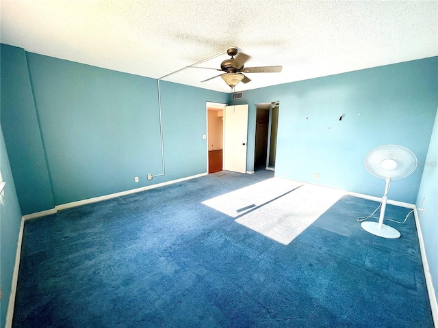 carpeted empty room with a textured ceiling and ceiling fan