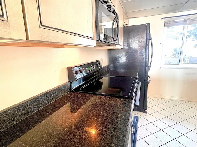 kitchen with light tile patterned floors and black appliances