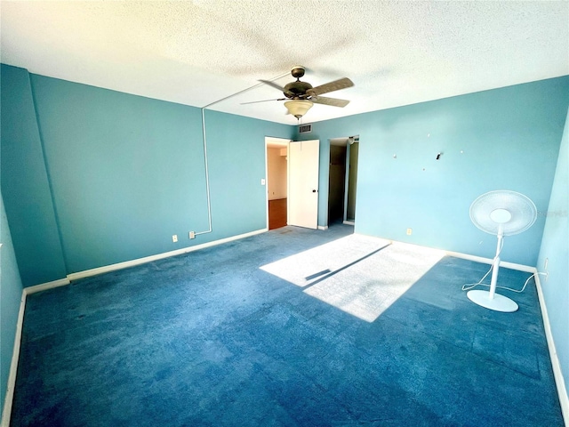 unfurnished bedroom featuring dark colored carpet, ceiling fan, and a textured ceiling