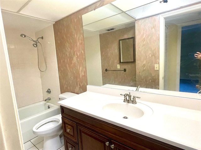 full bathroom featuring tile patterned floors, tiled shower / bath combo, toilet, and vanity