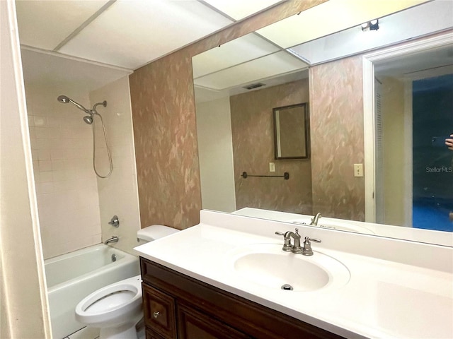 full bathroom with tiled shower / bath combo, toilet, and vanity