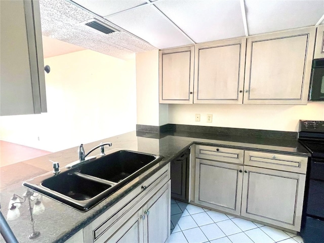 kitchen featuring range, sink, and light tile patterned floors