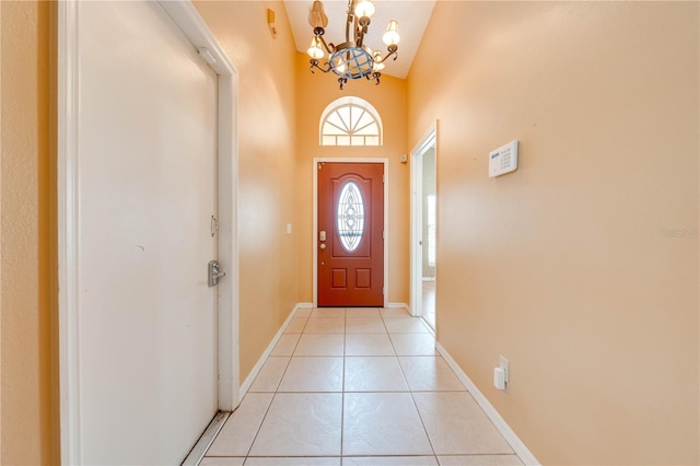 doorway to outside with light tile patterned flooring, a chandelier, and lofted ceiling