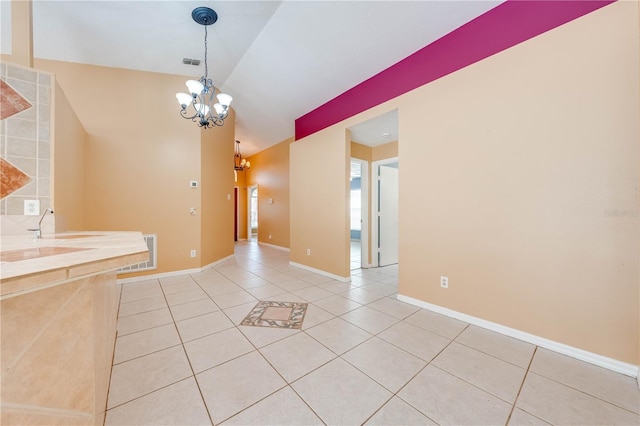 unfurnished dining area with vaulted ceiling, a notable chandelier, and light tile patterned floors