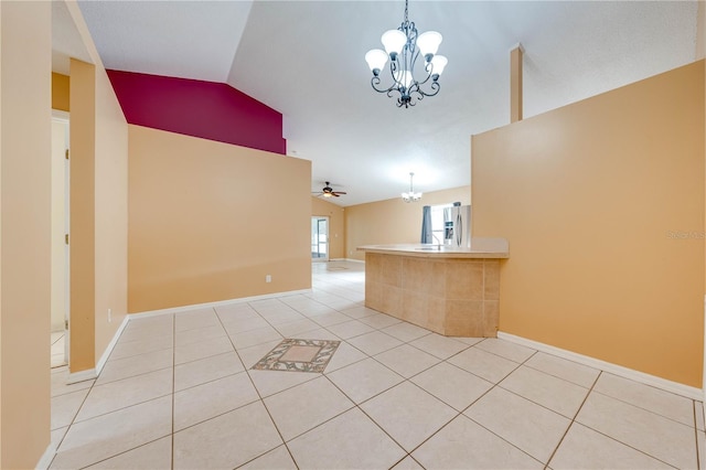 unfurnished room with ceiling fan with notable chandelier, light tile patterned floors, and vaulted ceiling