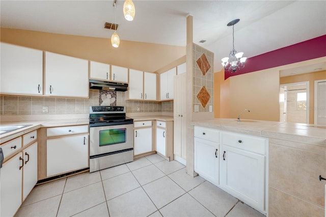 kitchen with white cabinetry, vaulted ceiling, stainless steel electric stove, and pendant lighting