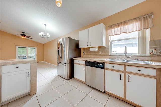 kitchen featuring white cabinetry, stainless steel appliances, a wealth of natural light, sink, and pendant lighting